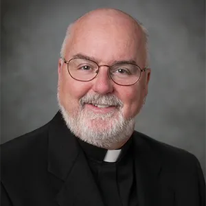 Portrait photo of Rev. O'Hara in professional attire.
